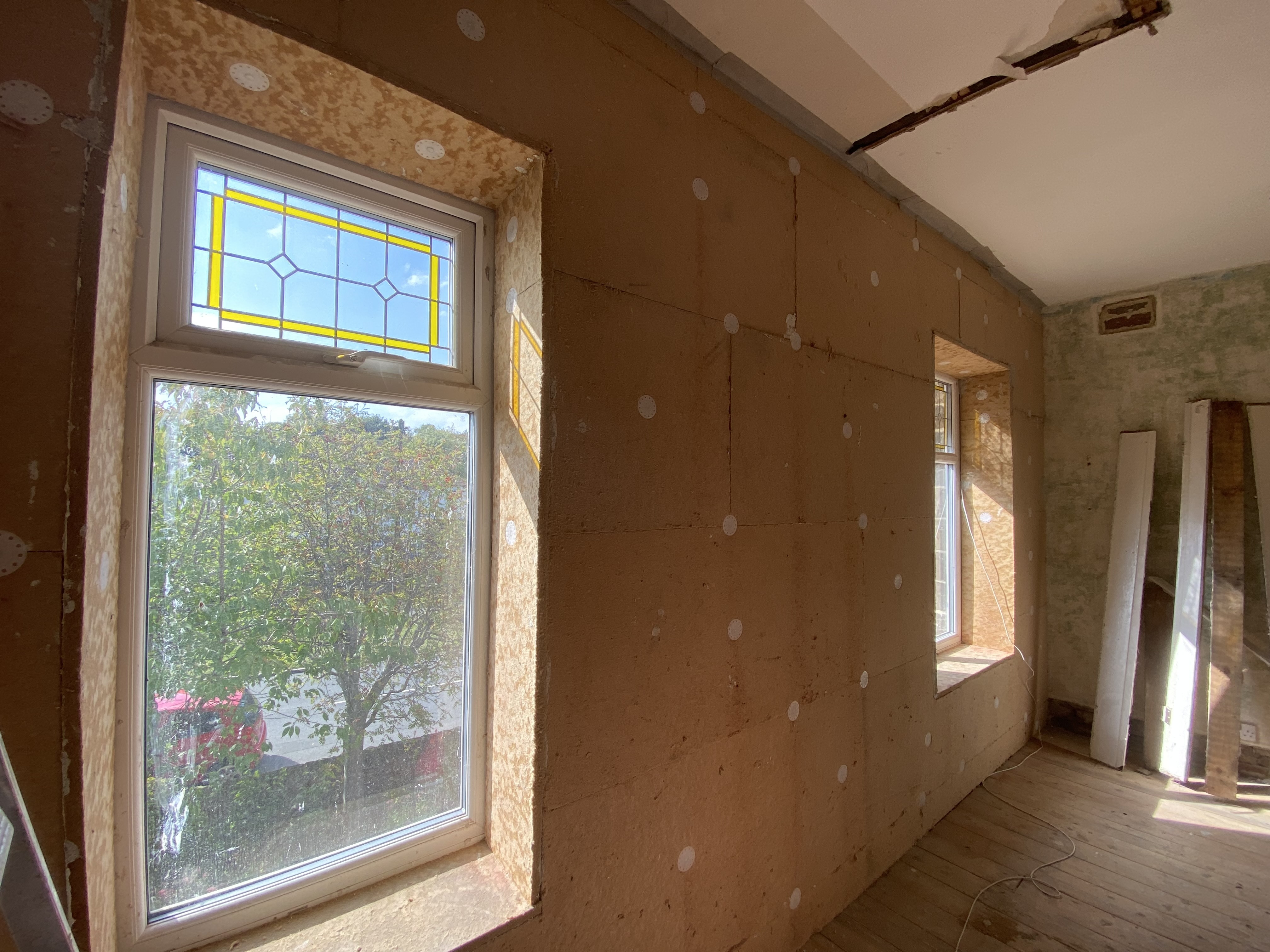 Internal wall insulation shown from the inside of a room with stained glass windows
